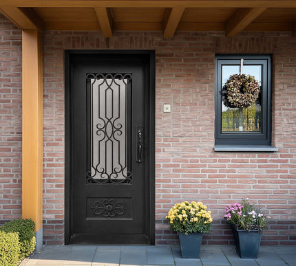 Black decorative iron entry door with scrollwork and kickplate