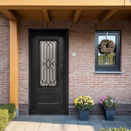 Black decorative iron entry door with scrollwork and kickplate