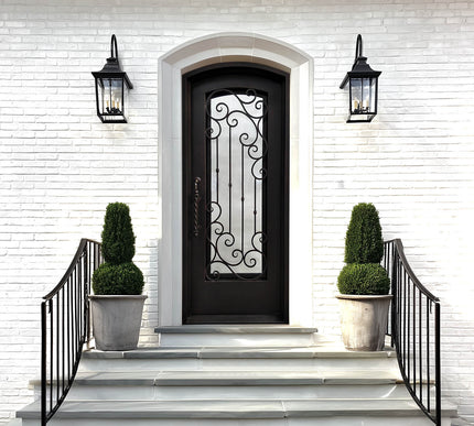 Decorative black front door with arched top and ornate scrollwork