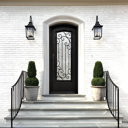 Decorative black front door with arched top and ornate scrollwork