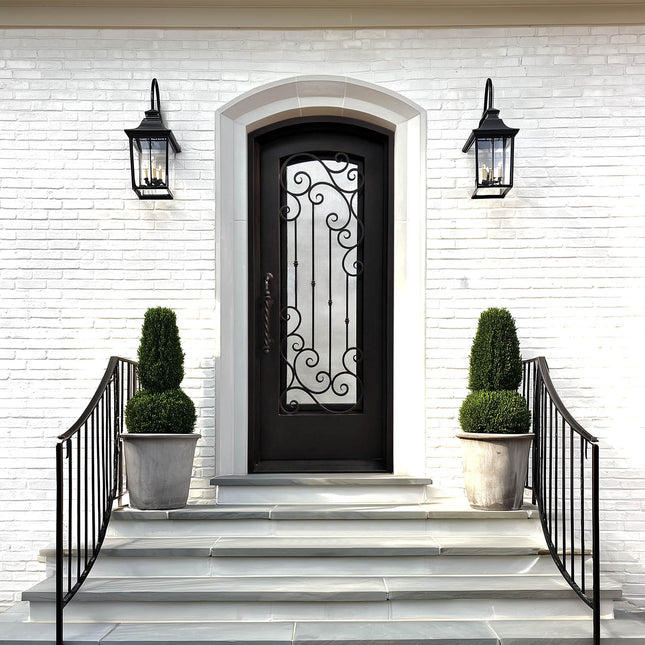 Decorative black front door with arched top and ornate scrollwork